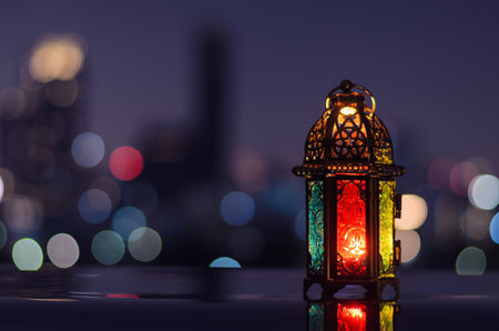 Lantern with night sky and city bokeh light background for the Muslim feast of the holy month of Ramadan Kareem.の写真素材