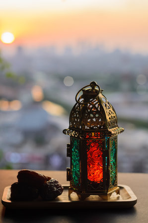 Lantern and dates fruit with dusk sky and city background for the Muslim feast of the holy month of Ramadan Kareem.の写真素材