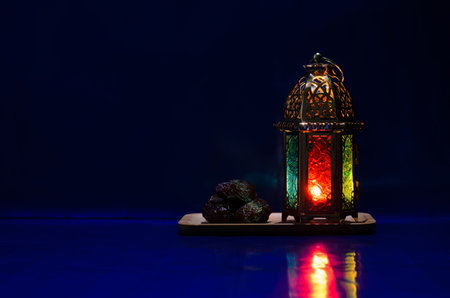 Lantern and dates fruit put on table with dark blue background for the Muslim feast of the holy month of Ramadan Kareem.の写真素材