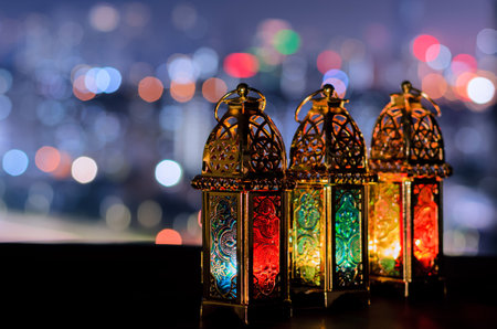 Lanterns with night sky and city bokeh light background for the Muslim feast of the holy month of Ramadan Kareem.の写真素材