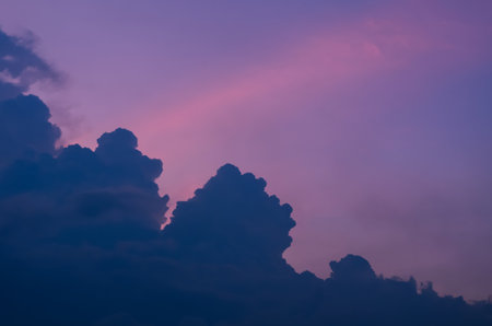 Blurred focus of dark cloud before rain with colorful sky in monsoon season.の写真素材