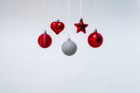 Hanging red ornaments on white background for Christmas holiday festival.の写真素材