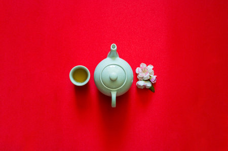 Tea set and peach blossom on red cloth background for Chinese new year concept.の写真素材