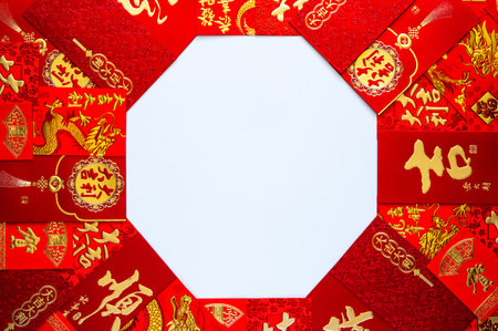 Chinese new year concept with red envelope packets or ang bao (words mean good luck, great prosperity, wealth, auspicious) on white background.の写真素材