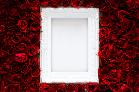 White photo frame that have white background on red roses for Valentine's and Mother day concept.の写真素材