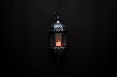 Black hanging lantern with light on dark background for the Muslim feast of the holy month of Ramadan Kareem.の写真素材