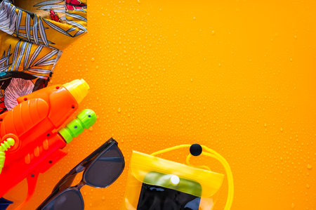 Colorful shirt with water gun, waterproof case for smartphone and sunglasses  for Songkran Festival celebration in Thailand.の写真素材