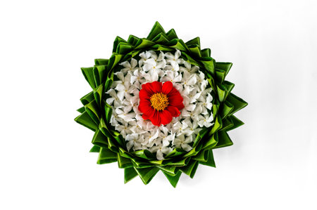 Top view of banana leaf Krathong decorates with colorful flowers for Thailand full moon or Loy Krathong festival isolated on white paper background.の写真素材