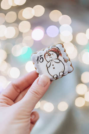 gingerbread advent calendar with numbers on the background of Christmas lightsの写真素材