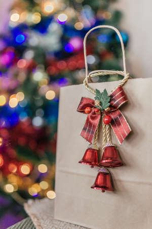 craft package with a gift on the background of a Christmas treeの写真素材