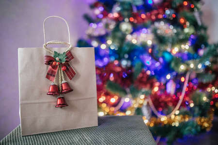 craft package with a gift on the background of a Christmas treeの写真素材