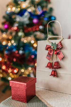 craft package with a gift on the background of a Christmas treeの写真素材