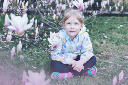 portrait girl with a spring flowering treeの写真素材
