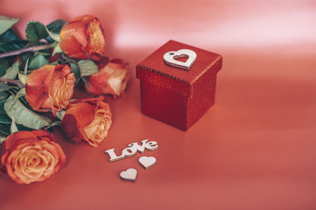 gift for the day of the holy valetina and flowers on a red backgroundの写真素材