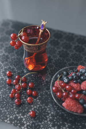 still life summer berries tea and sweets on the tableの写真素材