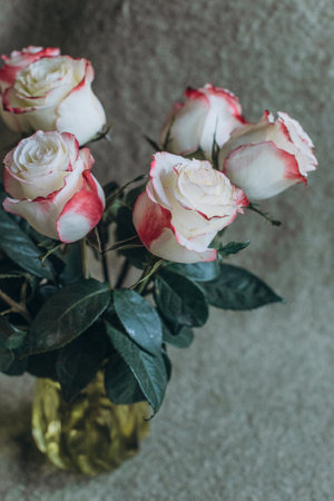 bouquet with roses in a vase on the tableの写真素材