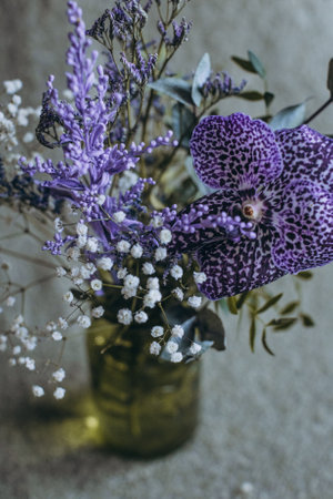 still life green vase with purple flowersの写真素材
