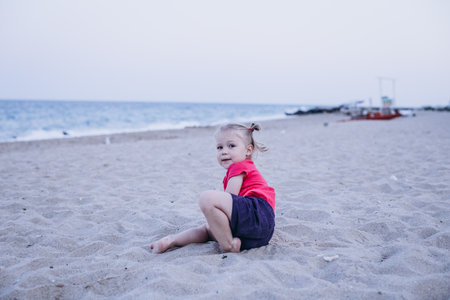 Portrait of a little girl on the seashore on the beachの写真素材