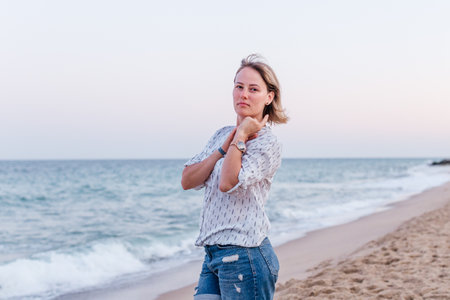 Portrait of a girl walking along the beach of the sea coastの写真素材
