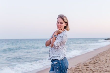Portrait of a girl walking along the beach of the sea coastの写真素材