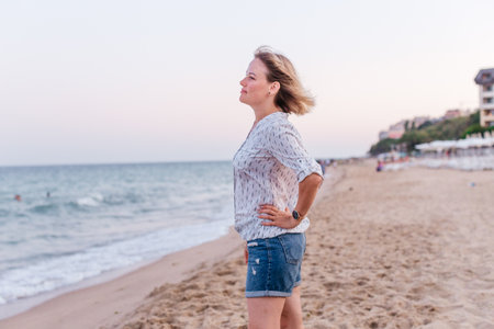 Portrait of a girl walking along the beach of the sea coastの写真素材