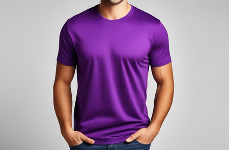 Man in purple t-shirt on gray background. Mockup for designの素材