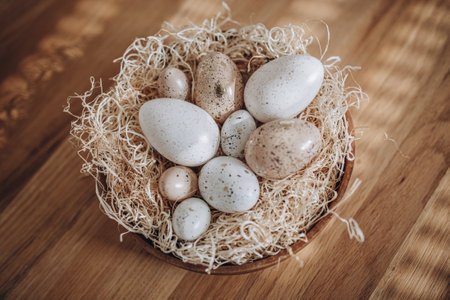 Easter eggs in a nest on a wooden background. Vintage style.