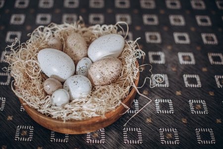 Easter eggs in a basket on a wooden background. Toned.の写真素材