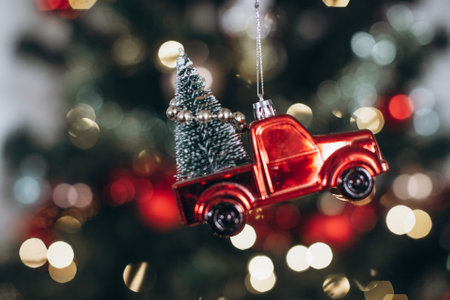 Christmas tree with red toy car on bokeh background, vintage toneの写真素材