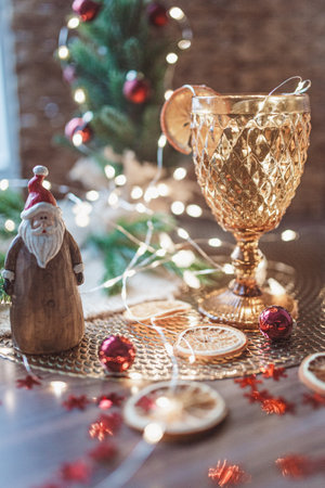 Christmas still life with golden wine glass, Christmas tree and Santa Clausの写真素材