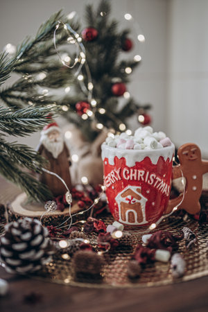 Cup of hot chocolate with marshmallows and gingerbread man in christmas decorationの写真素材