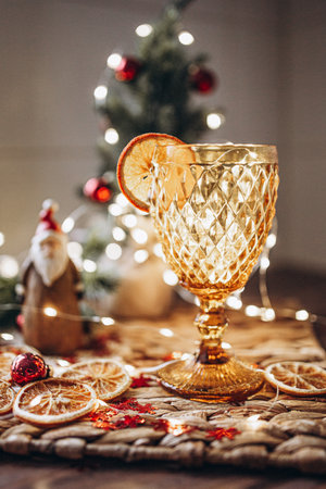 Christmas still life with wine glass and christmas tree on wooden backgroundの写真素材