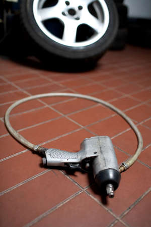 pneumatic wheel wrench on the garage florの写真素材