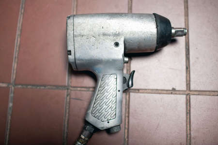 pneumatic wheel wrench on the garage florの写真素材