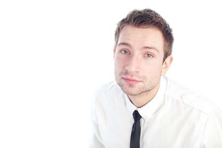 Portrait of young businessman sitting and looking up isolated on white.の写真素材