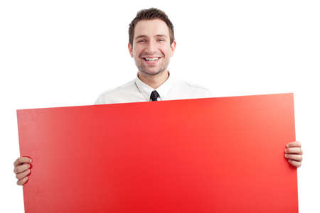 Young Businessman holding red blank sign and smiling isolated on white. You can add your idea on the sign.の写真素材