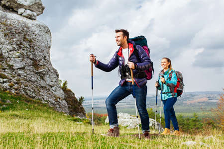 Backpackers hiking. Two young tourists on the trialの写真素材