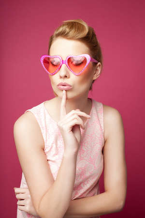 Valentine's day. Retro woman with heart sunglasses.の写真素材