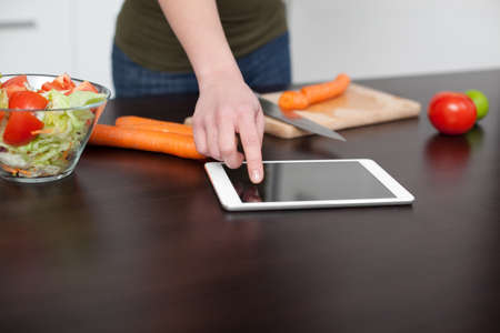 Checking recipe on digital tabletの写真素材