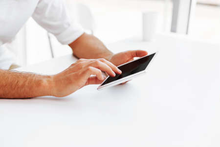 Man usign digital tablet at the desk