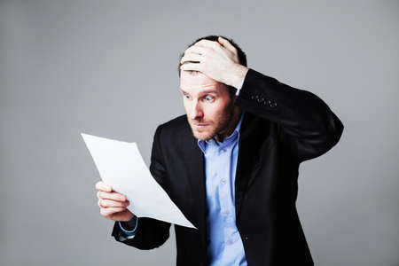terrified businessman reading documentの写真素材