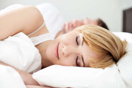 Portrait of couple sleeping in the bedの写真素材