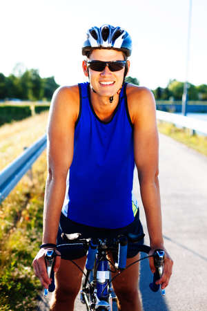 Happy young man with his  bicycle