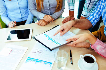 Close-up of corporate business people working at the table