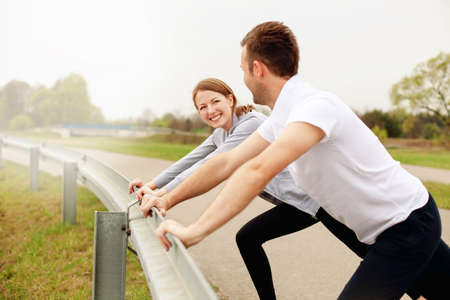 Couple stretching before running at the morning