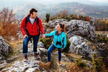 Young couple enjoying the moment on the rocksの写真素材