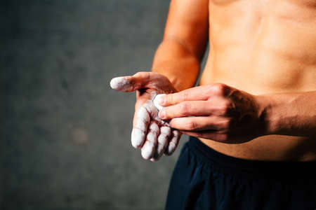 Close-up of a sportsman putting some talc on his handsの写真素材