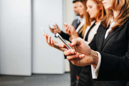 Close up of businessman using smartphone. Business conceptの写真素材