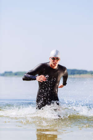 Triathlonist getting out of water after a race