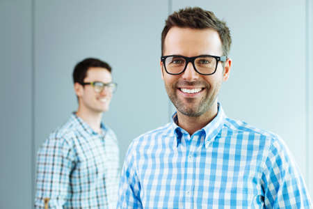 Two computer geeks standing in officeの写真素材